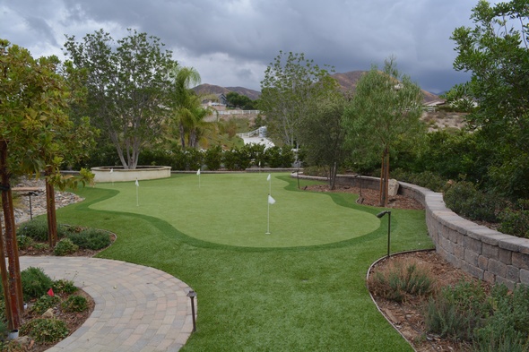 Edmonton Synthetic grass golf green in a landscaped backyard